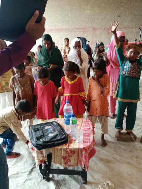Photograph 2 of 13 sent from the ministry in Pakistan: children and families gathered outdoors
