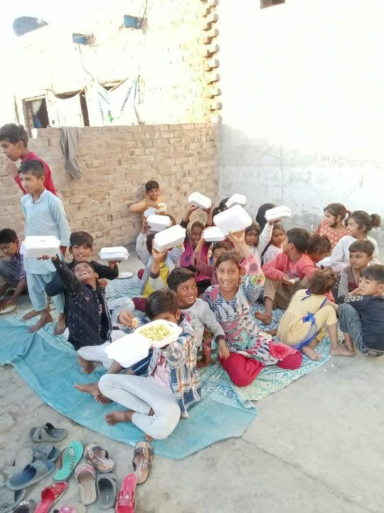 Photograph 5 of 13 sent from the ministry in Pakistan: children and families gathered outdoors