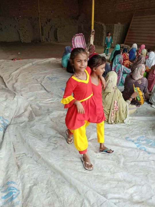 Photograph 7 of 13 sent from the ministry in Pakistan: children and families gathered outdoors