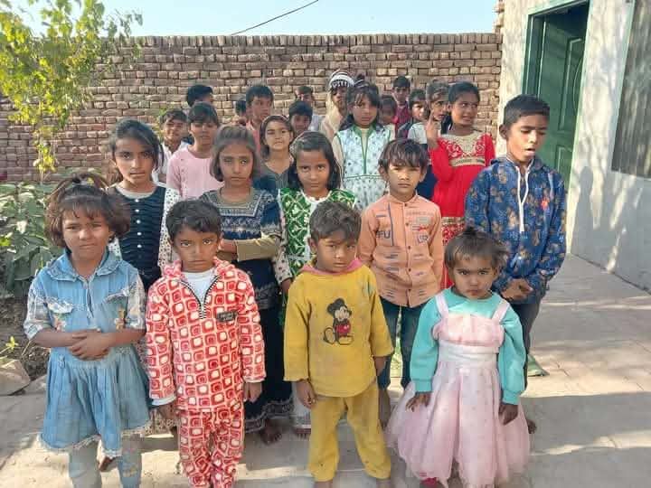 Photograph 8 of 13 sent from the ministry in Pakistan: children and families gathered outdoors