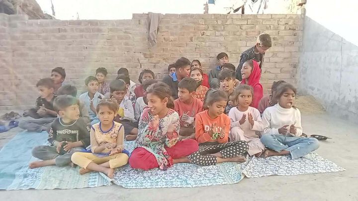 Photograph 11 of 13 sent from the ministry in Pakistan: children and families gathered outdoors