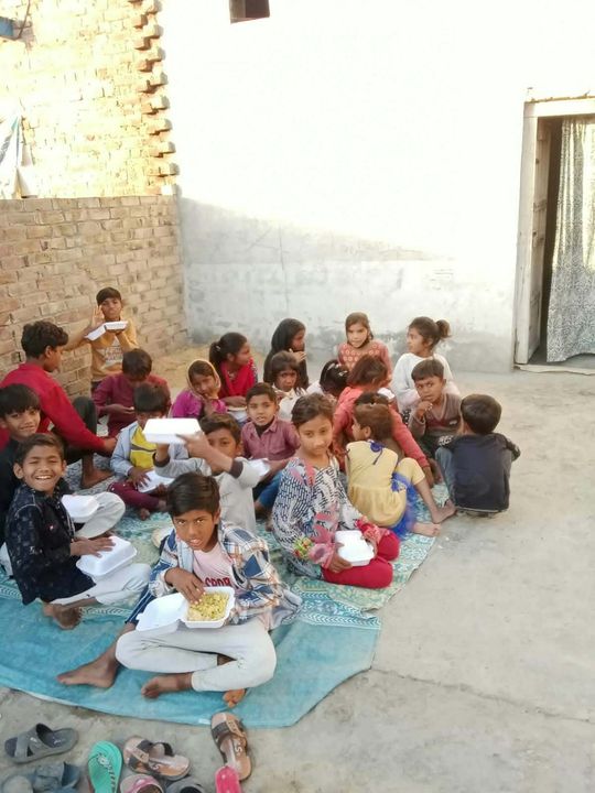 Photograph 12 of 13 sent from the ministry in Pakistan: children and families gathered outdoors
